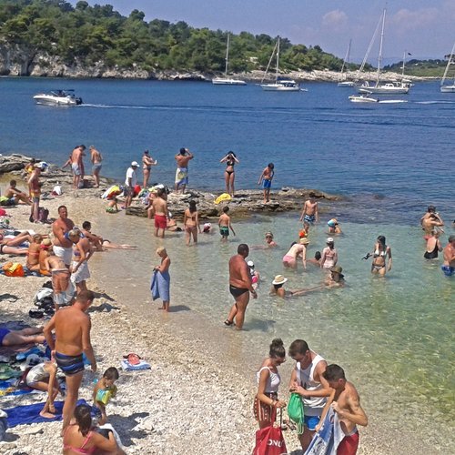 Amateur beach girls voyeured topless in the water